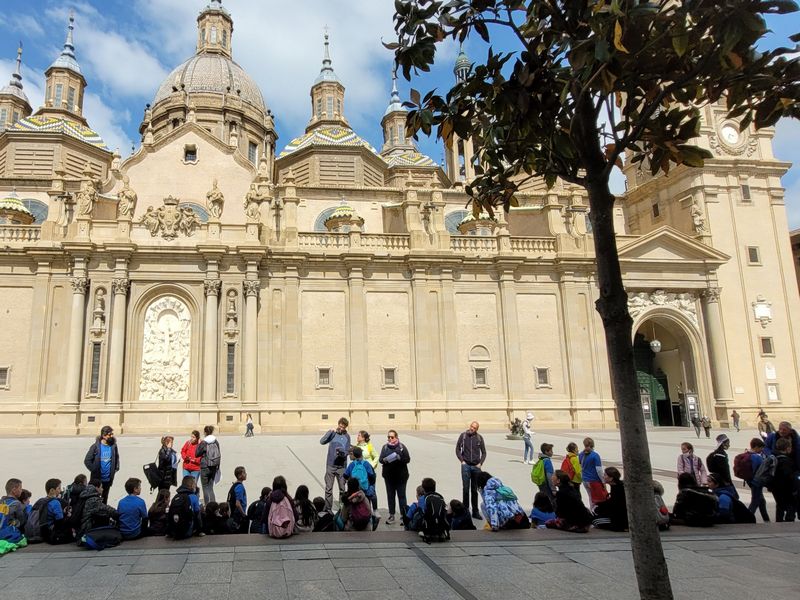 Groupe d\élèves sur la place du Pilar, devant la façade de la basilque